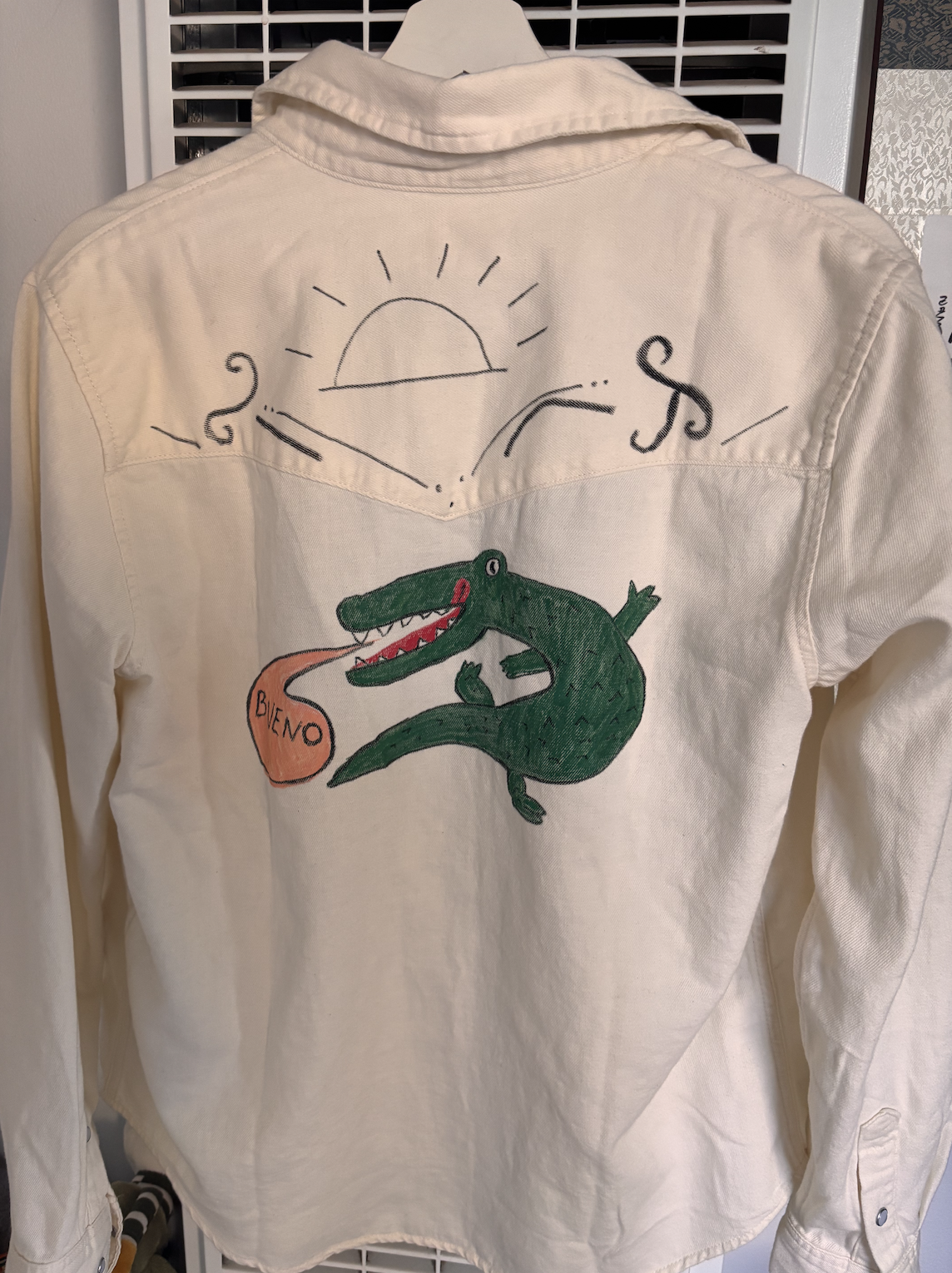 hands drawing on a denim jacket